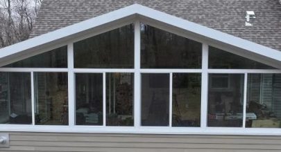 Modern sunroom with expansive glass windows for natural light.